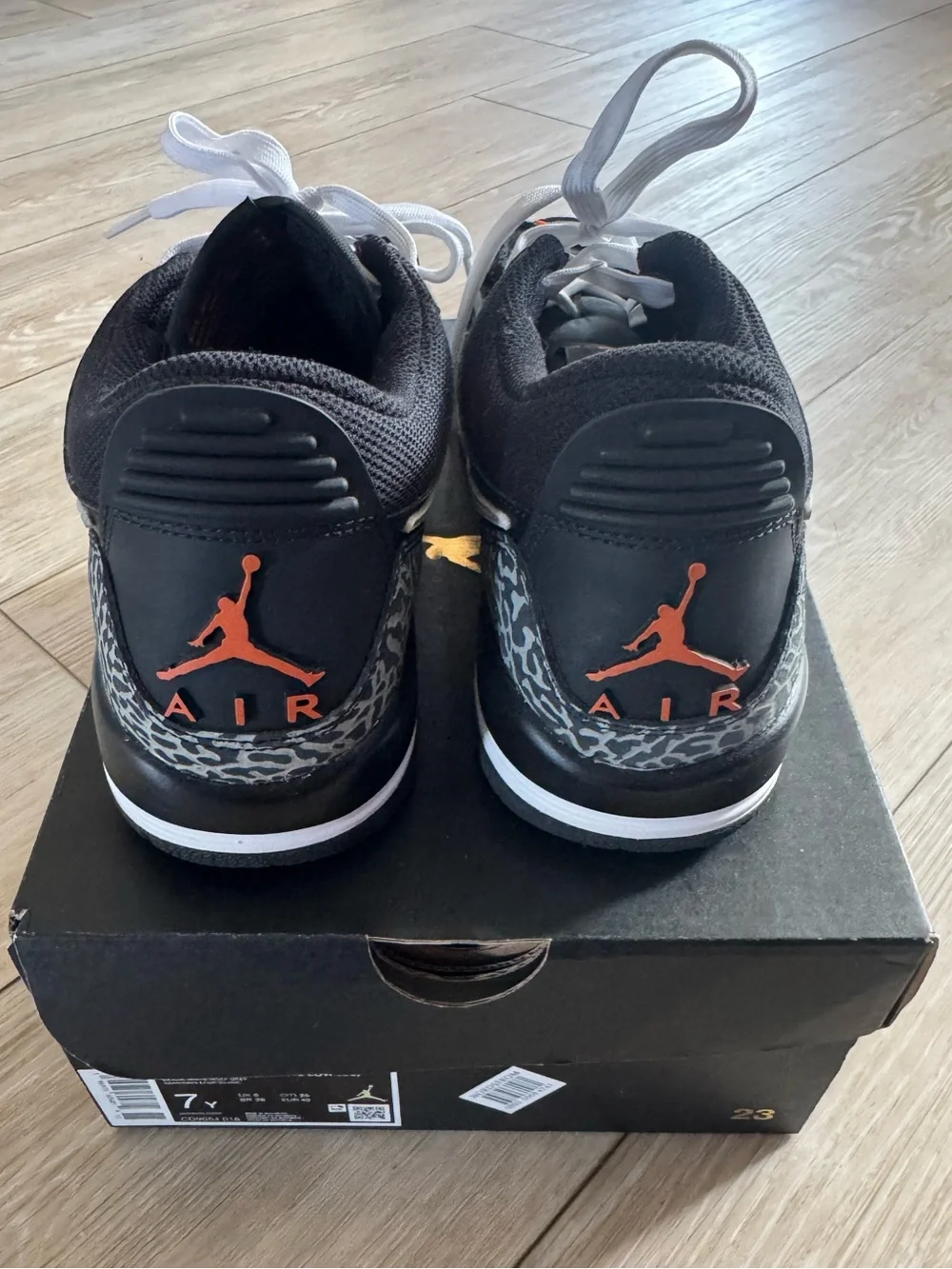Nike Men’s Black and White Sneakers with Orange Logo Accent